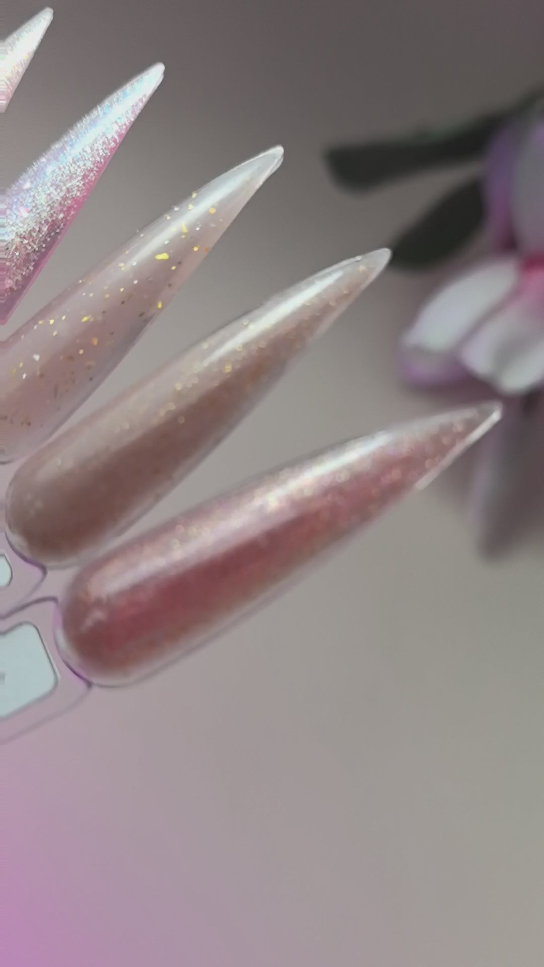 Close-up of nails enhanced with Brocade Builder Gel 05 showing glittery finish on a neutral color, suitable for strengthening nails.